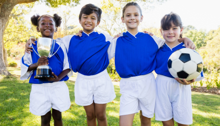 Youth football players holding a trophy